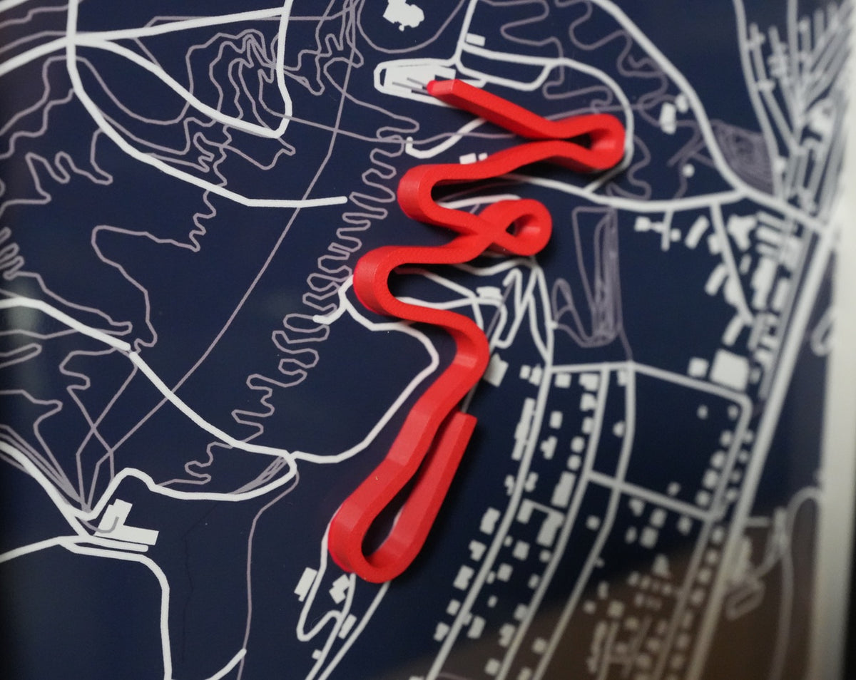 Close-up of a bobsleigh track display showing the detailed track outline and finish.