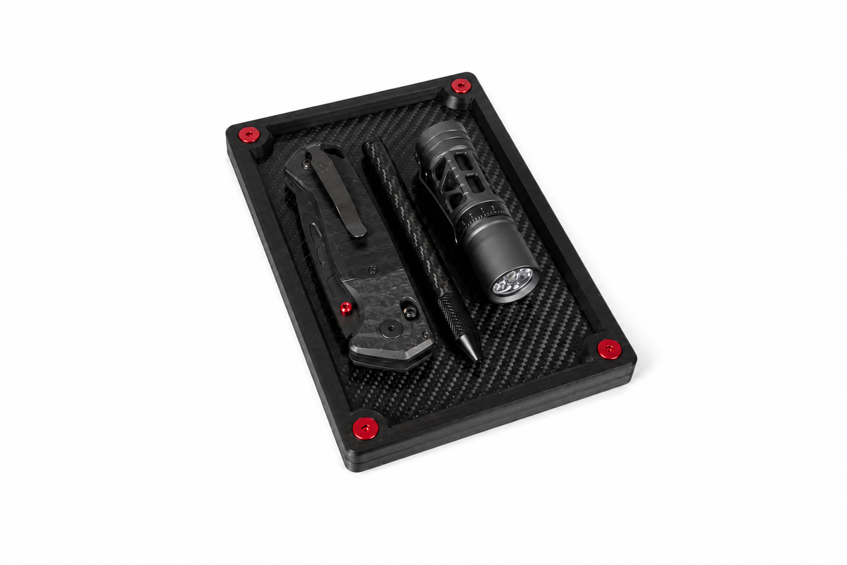 Small carbon fibre organiser tray used to organise keys, wallet and other everyday carry essentials.