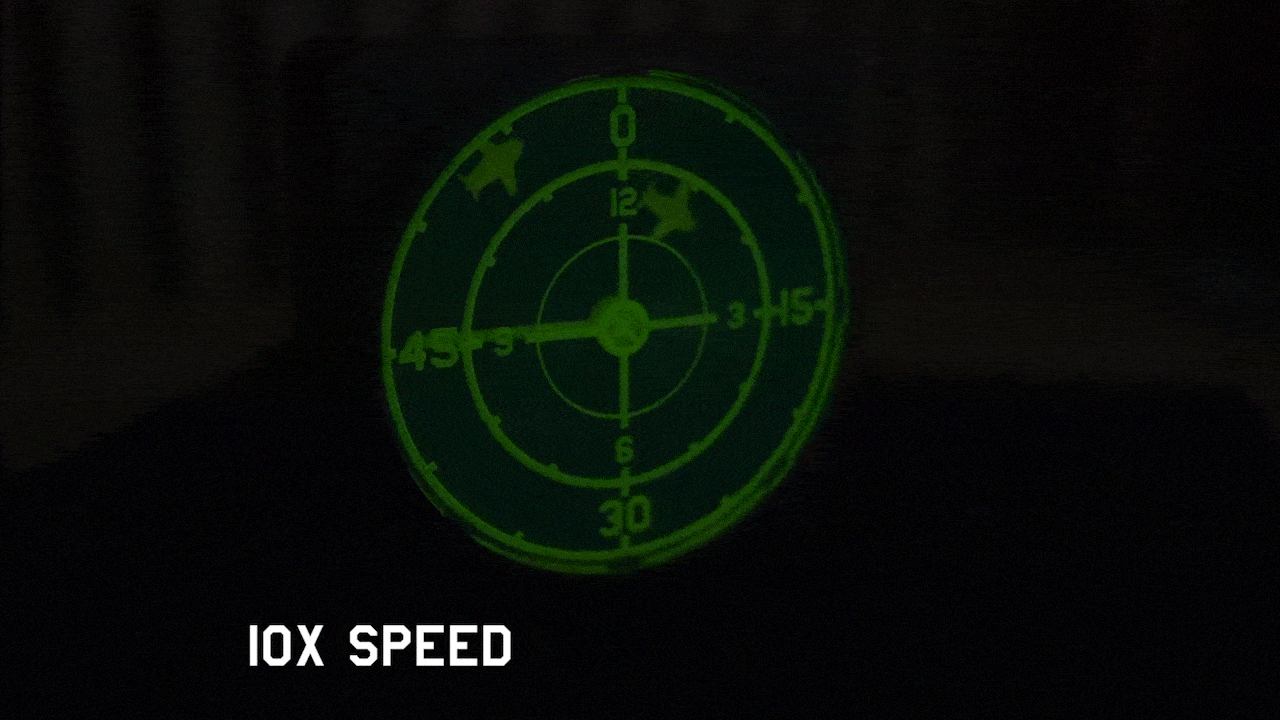 Animated green radar wall clock showing sweeping radar motion and moving aircraft markers.